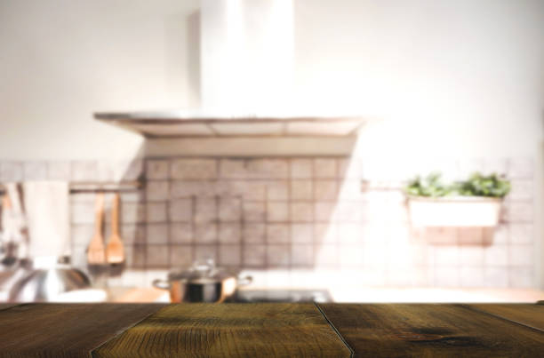 istock Wood table on blur Interior of kitchen background 827910254