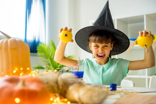 istock Girl playing with pumpkins 827910490
