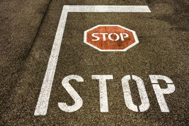 istock stop sign on city asphalt floor with symbol 827911316