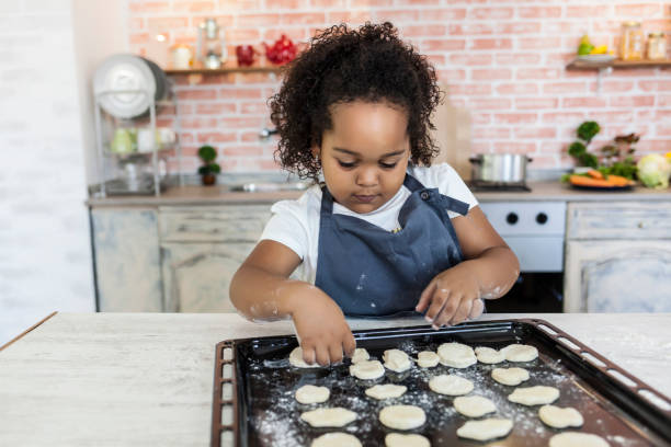 istock Little girl preparing homemade biscuits 827918166