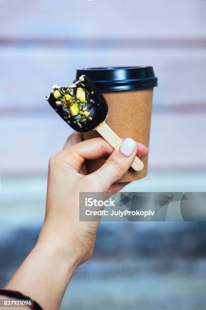 Womans Hand Holding Chocolate Popsicle Stock Photo - Download Image Now - Adult, Adults Only, Adventure