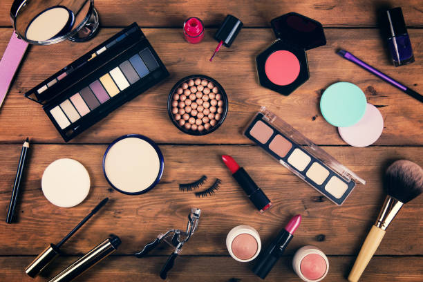 istock makeup cosmetics on wooden background. top view 827921712