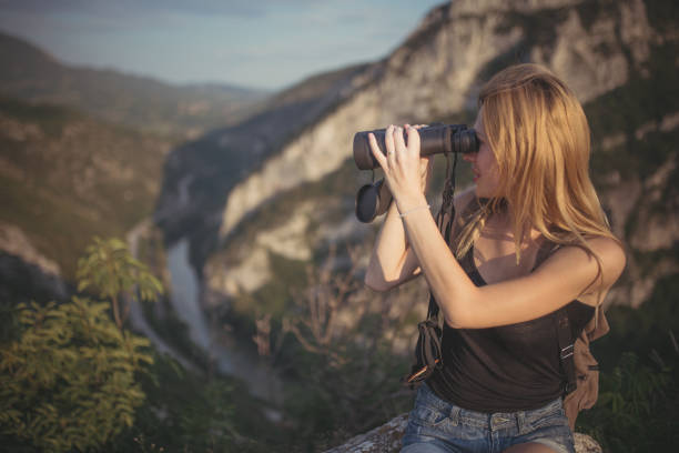 istock Woman with binoculars on the mountain 827926060