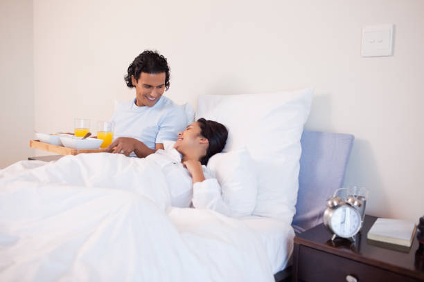istock Man brought breakfast to the bed for his girlfriend 827926098