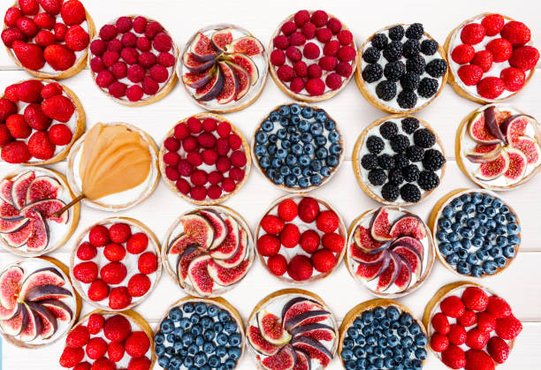 istock Fruit and Berry tarts dessert isolated on white background, top view 827929400
