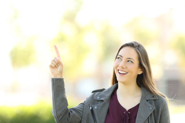 istock Presenter woman pointing above 827933058