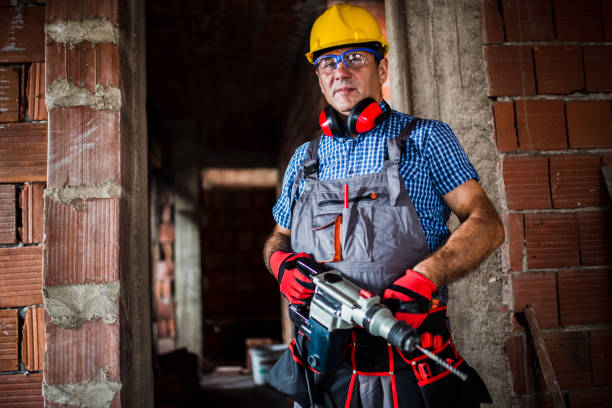 istock Portrait of a man holding drill 827935054