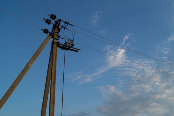 istock Electrical post by the road against blue sky with clouds 827941500