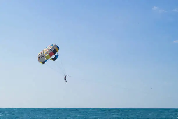 Photo of Parasailing is a popular pastime in many resorts around the world. Focus on a parachute. The active form of relaxation.