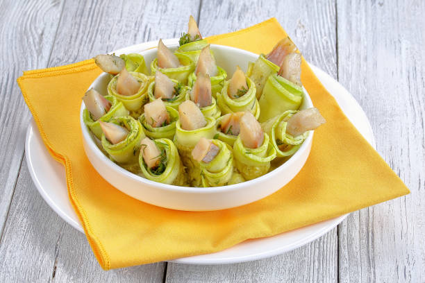 istock tasty spicy zucchini rolls with herring 827944096