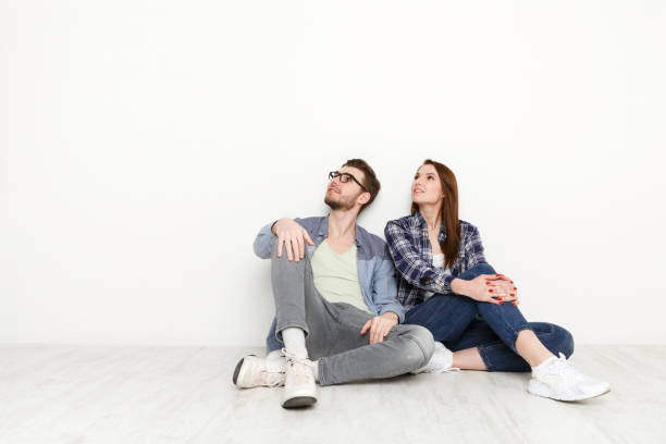 istock Couple looks up at white background 827946570