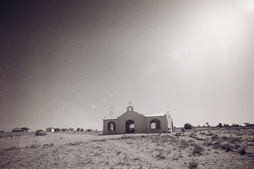 An old open church with a cross on top in the desert with the sun shining down it Lake Turkana Northern Kenya East Africa