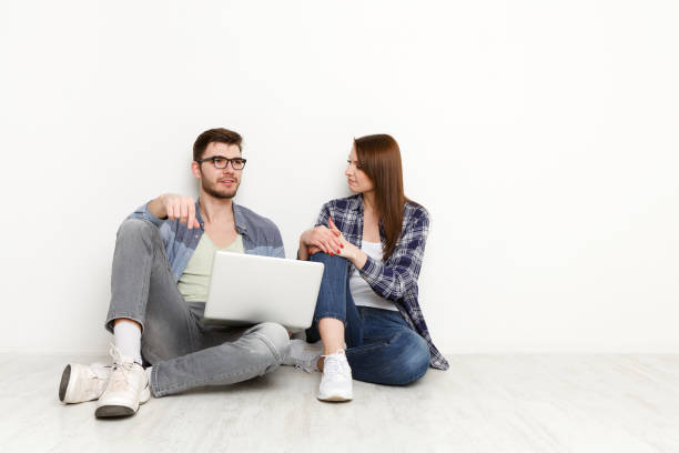 istock Couple with laptop thinking over new work project at home interior 827947292