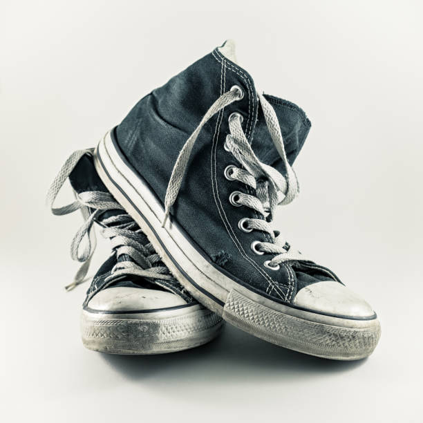 istock Old and worn pair of sneakers with white background 827950518