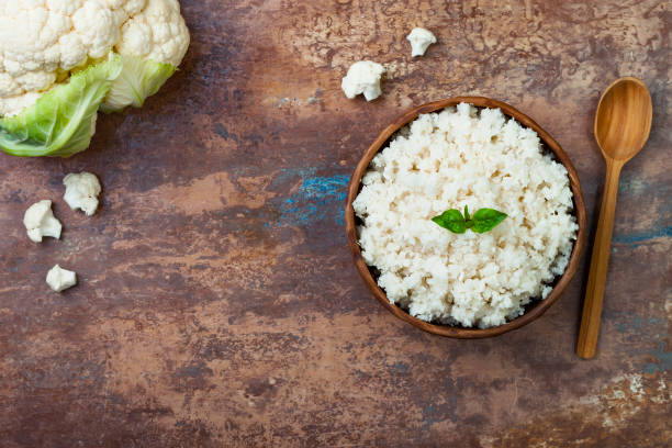 Cauliflower rice in a bowl. Top view, overhead, copy space stock photo