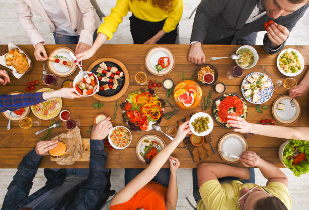 istock People eat healthy meals at served table dinner party 827951640