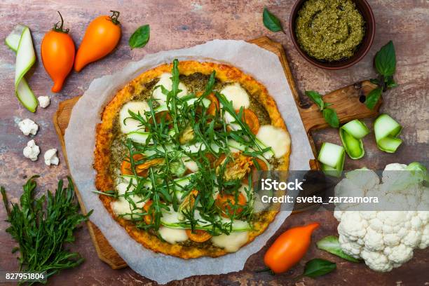 Cauliflower Pizza Crust With Pesto Yellow Tomatoes Zucchini Mozzarella Cheese And Squash Blossom Stock Photo - Download Image Now