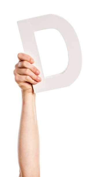 istock Woman's hand and arm holds up 3-D capital letter D 827954180