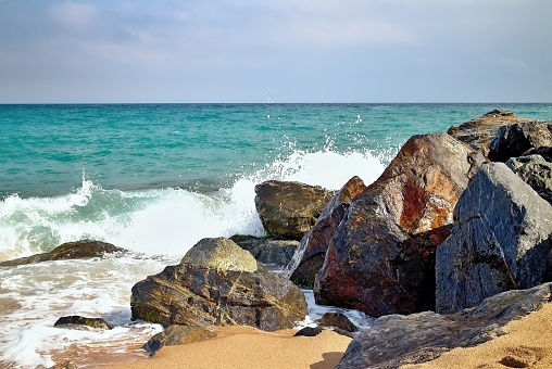 Olas del mar golpeando la rocosa Playa de Malgrat de Mar, España photo
