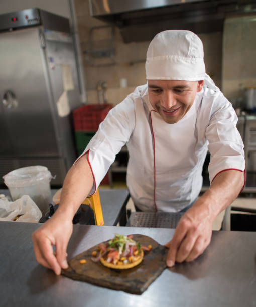 istock Cook serving a plate at a restaurant 827959208
