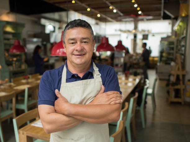 istock Happy man working as a waiter at a restaurant 827959224