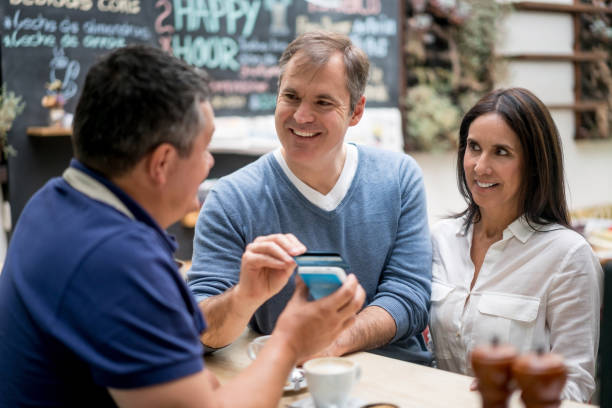 istock Couple making a contactless payment at a cafe 827959388