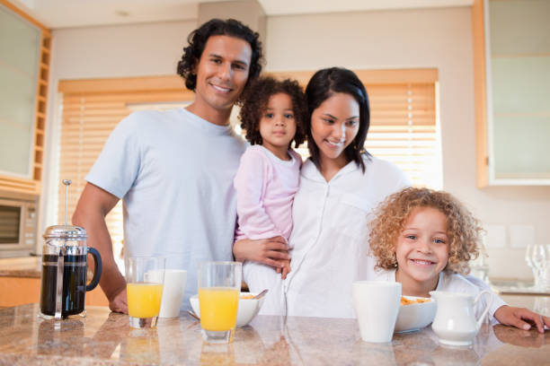 istock Happy family having breakfast in the kitchen together 827962180