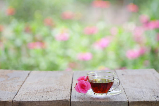 Red tea and flower on wooden table