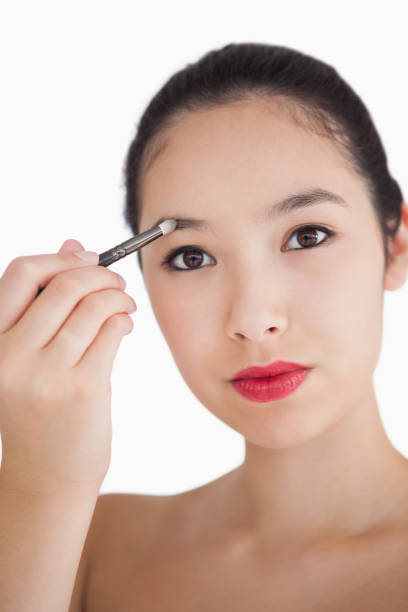 istock Woman filling in eyebrows 827963092