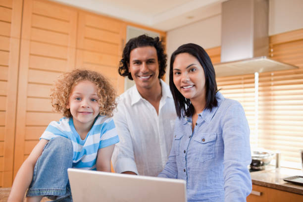istock Joyful family surfing the internet in the kitchen together 827963182