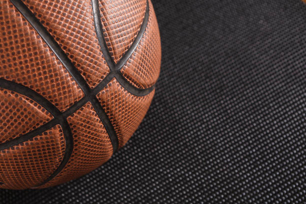 istock Old basketball ball on black background copy space 827970574