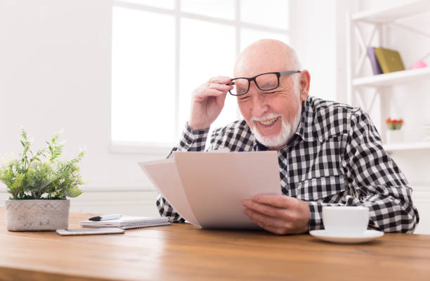 istock Cheerful senior man looking photos, copy space 827979506
