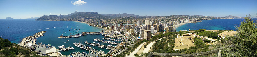Costa Blanca Panorama. Panoramic view of Calpe from famous rock - Penon de Ifach, overlooking the coast, the harbor, lake and the city.