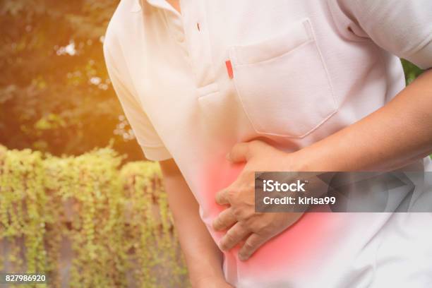 Male Suffering From Stomachache Pain A Man Stomachache At Outdoor Healthy Concept Stock Photo - Download Image Now