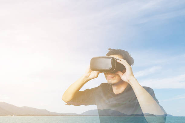 istock Man in a VR glasses operating in virtual reality ocean, 827987414