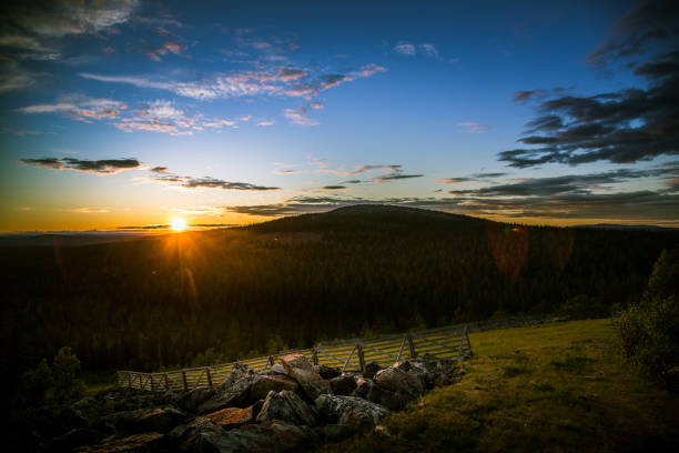 istock A beautiful landscape with a midnight sun above arctic circle. Dreamy scenery with light flares 827988252