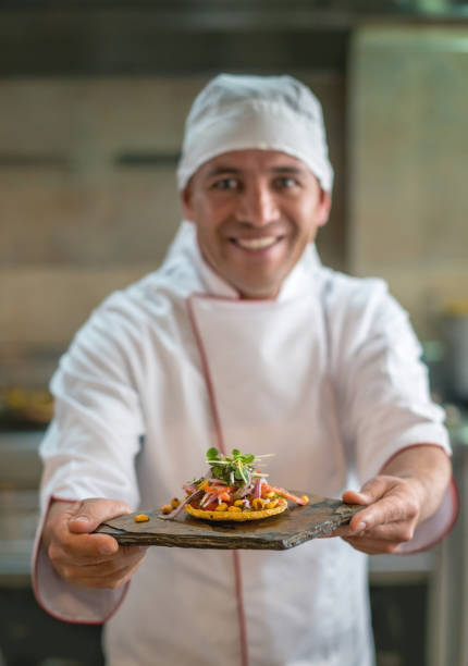 istock Happy chef serving a plate at a restaurant 827992064