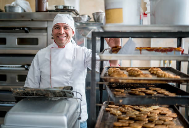 istock Happy baker working at a bakery shop 827992104
