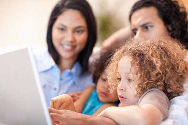 istock Cheerful family using laptop together 827999228