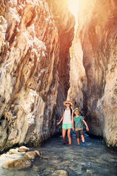 istock Kids hiking along river canyon in mountains 827999928