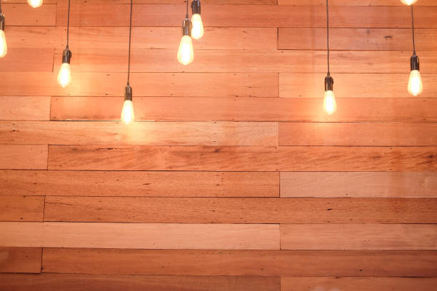 istock Retro lamp with cable hanging on the wooden wall 828005482