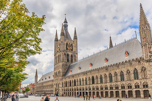 Ypres is a city in the Flanders Region of Belgium rich of beautiful buildings. Almost totally destroyed after the First World War, it was carefully and faithfully rebuilt: an example is the Cloth Hall, now a UNESCO World Heritage Site. Tourists in Grote Markt.