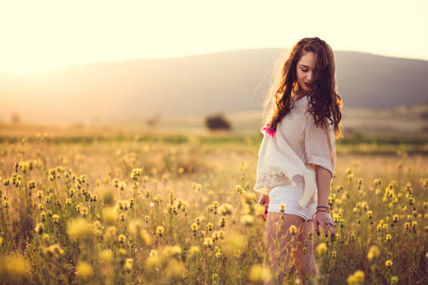 istock Romantic Girl In Sunny Field 828008784