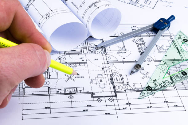 istock Architectural blueprints and blueprint rolls and a drawing instruments on the worktable. Drawing compass, plans. Civil Engineering, Construction background. 828012538