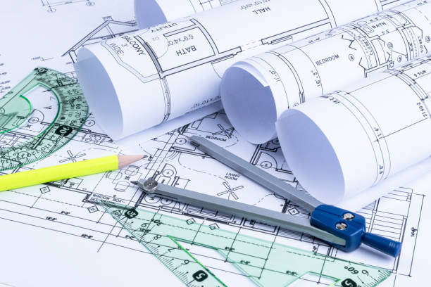 istock Architectural blueprints and blueprint rolls and a drawing instruments on the worktable. Drawing compass, plans. Civil Engineering, Construction background. 828013360