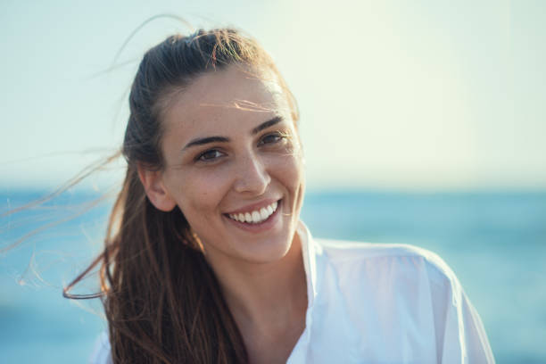 istock Young smiling girl at the beach 828018032