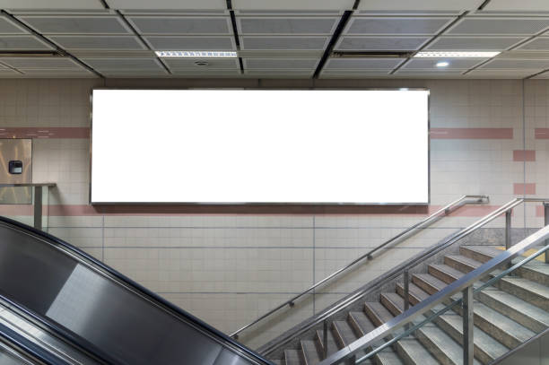 istock Blank billboard located in underground hall or subway for advertising, mockup concept, Low light speed shutter 828018114