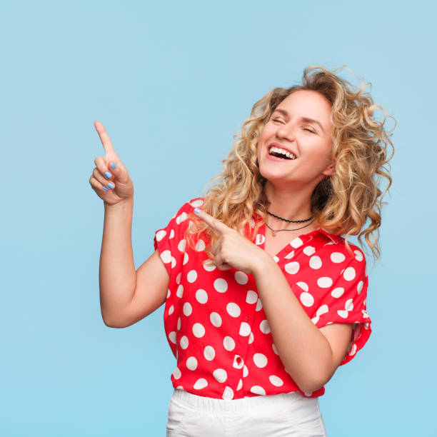 istock Laughing woman pointing away 828036086