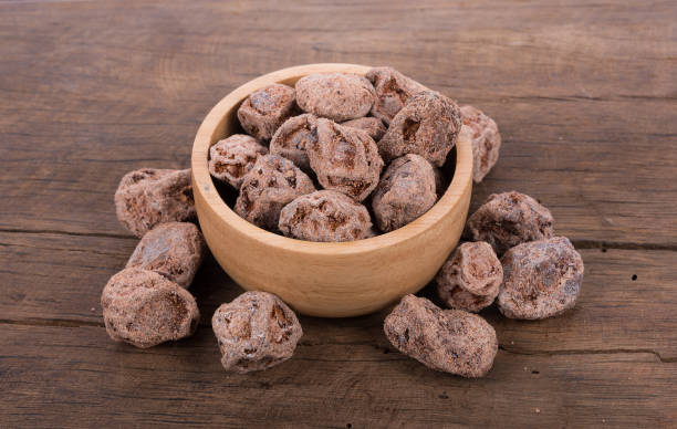 istock Salted Plum on wooden Background 828038314