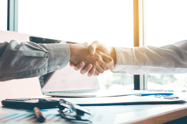 istock Business people accept or confirm project on the proposal and join shaking hands at office room company. 828038712